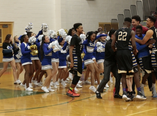 Sierra Vista cheerleaders and basketball players celebrate a 67-64 double overtime win over ...