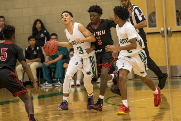 Chris Jackson (3) of the Rancho Rams is bumped by Ronald Daniels (3) of the Las Vegas Wildca ...