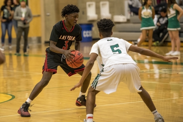 Ronald Daniels (3) of the Las Vegas Wildcats holds the ball while being defended by Kevin Da ...