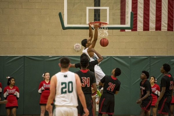 Lamont Traylor (33) of the Rancho Rams dunks the ball against the Las Vegas Wildcats during ...