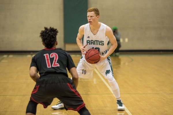 Tommy Robertson (10) of the Rancho Rams holds the ball as Donovan Joyner (12) of the Las Veg ...