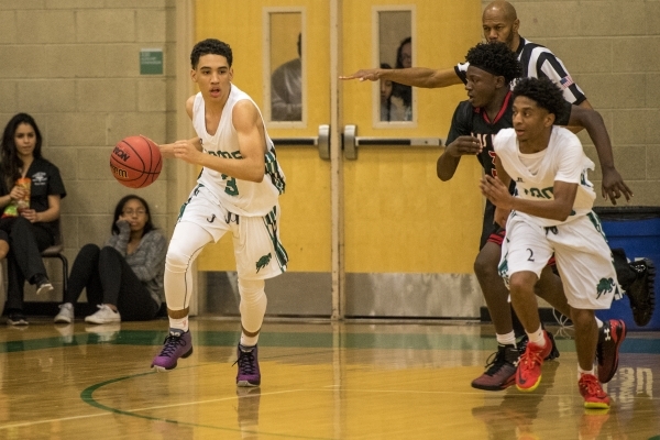 Chris Jackson (3) of the Rancho Rams drives with the ball during a basketball game against t ...