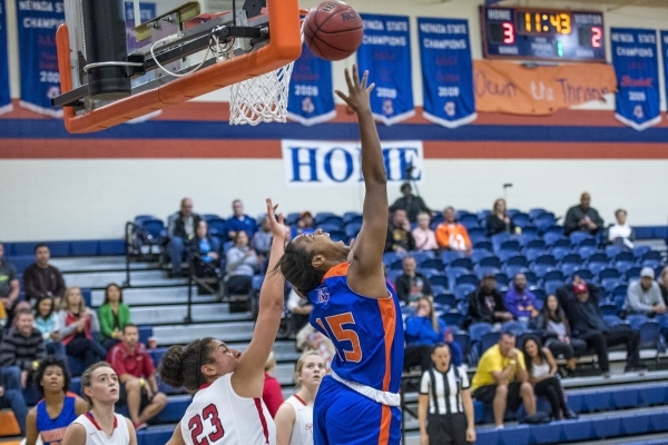 Madison Washington (15) of the Bishop Gorman Lady Gaels shoots the ball as Jess Brown (23) o ...