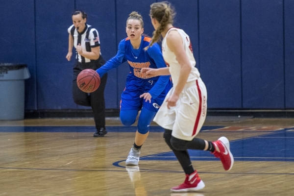 Megan Jacobs (23) of the Bishop Gorman Lady Gaels drives to the basket against the Castle Vi ...