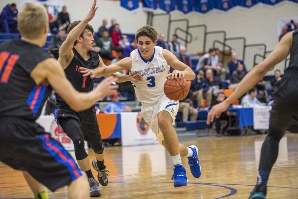 Bishop Gorman forward Byron Frohnen (3) drives to the basket while being defended by Timpvie ...