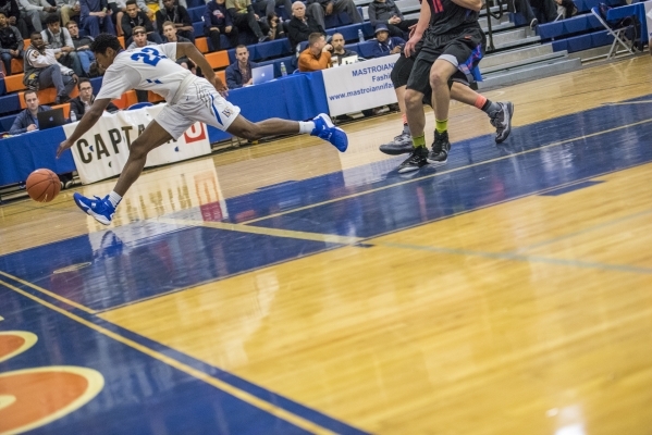Bishop Gorman guard Christian Popoola Jr. (22) chases a ball while playing against Timpview ...
