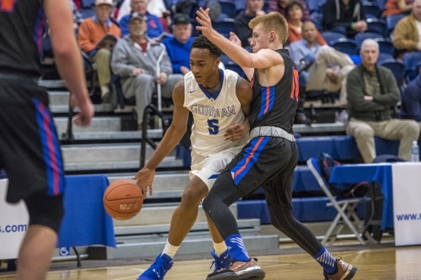 Bishop Gorman guard Chuck O‘Bannon (5) drives to the basket past Timpview (Utah) guard ...