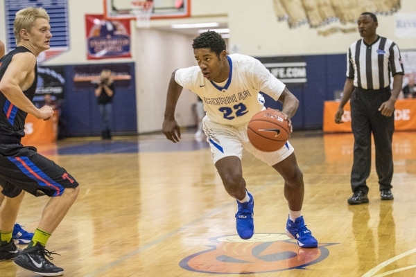 Bishop Gorman guard Christian Popoola Jr. (22) drives to the basket while being defended by ...