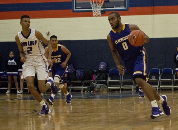 Lynwood High School‘s Jamal Bogan (0) works the ball up the court during their game ag ...