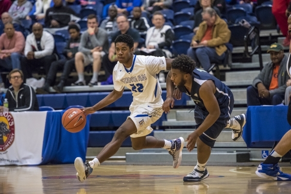 Bishop Gorman guard Christian Popoola Jr. (22) runs with the ball while being defended by Ov ...