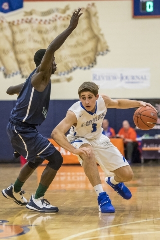 Bishop Gorman forward Byron Frohnen (3) is defended by Overland, Colo., player Alijah Hallib ...