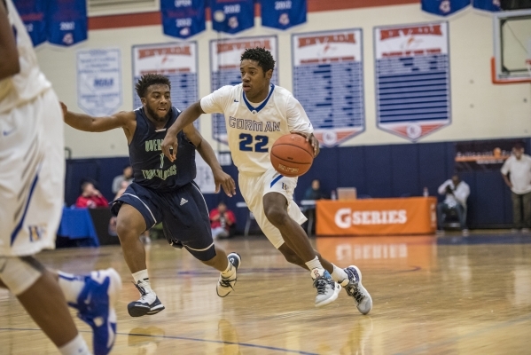 Bishop Gorman guard Christian Popoola Jr. (22) drives to the net past Overland, Colo., playe ...