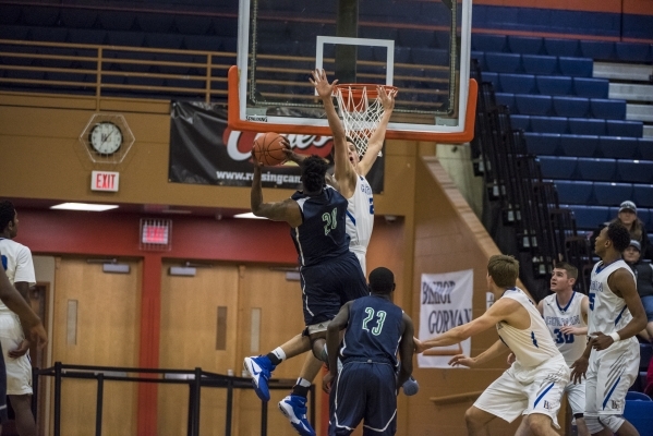 Bishop Gorman center Zach Collins (12) puts his hand up to block a shot by Overland, Colo., ...