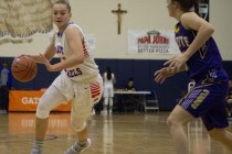 Bishop Gorman‘s Megan Jacobs (23) takes the ball up the court as Nyah Hall (3) of the ...