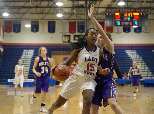 Bishop Gorman‘s Madison Washington (15) works the ball around Abigail Moerkerke (3) of ...