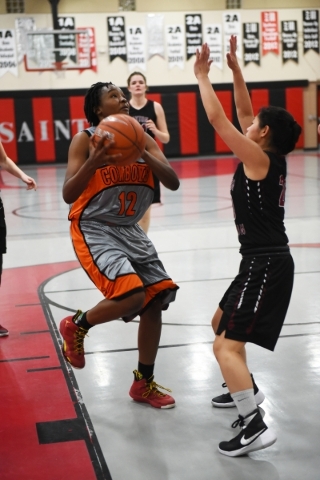 Chaparral‘s Shanice Aycox (12) goes up for a shot against Utah‘s Layton Christia ...