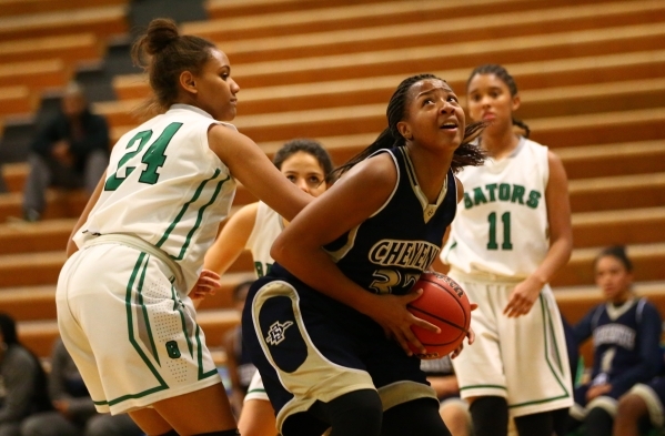 Cheyenne‘s Da‘Vione Lomax (32) looks to shoot as Green Valley‘s Samara Mil ...