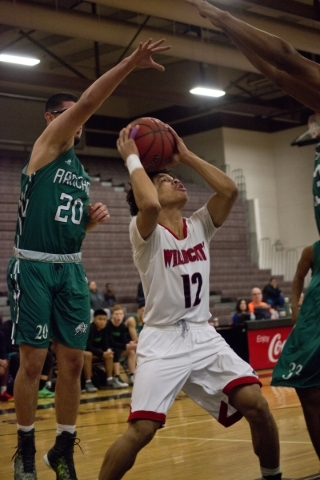 Las Vegas‘ Donovan Joyner (12) works the ball toward the net as Rancho‘s Michael ...