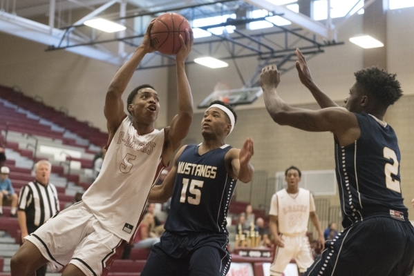 Aamondae Coleman (5) of Desert Oasis prepares to shoot against Shadow Ridge‘s Vernon S ...