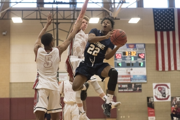 Shadow Ridge‘s James Fuller (22) prepares to shoot against Desert Oasis players Jacob ...