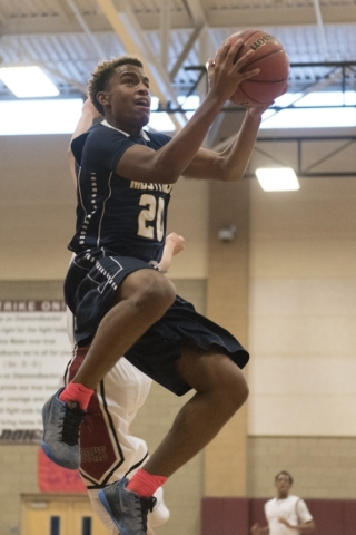 Shadow Ridge‘s Isaiah Williams (20) prepares to shoot against Desert Oasis during the ...