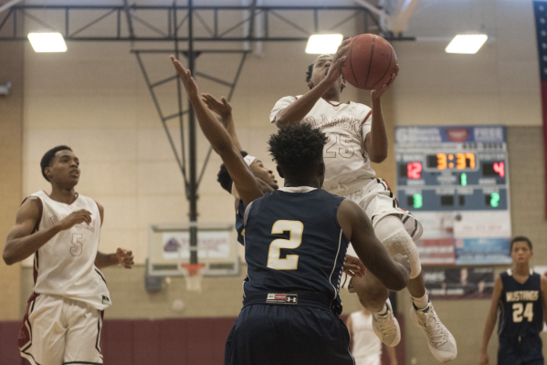 Drevin Cannon (25) of Desert Oasis prepares to shoot against Shadow Ridge‘s Kyle Brown ...