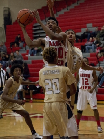 Arbor View‘­s Sevonyae Smith (30) shoots over Shadow Ridge‘s Isaiah Williams (2 ...