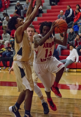 Arbor View‘­s Cameron Trailer (15) works the ball around Shadow Ridge‘s Kevin B ...