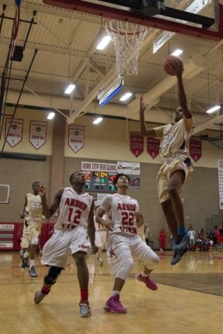 Shadow Ridge‘s Isaiah Williams (20) takes the ball to the net during their game at Arb ...