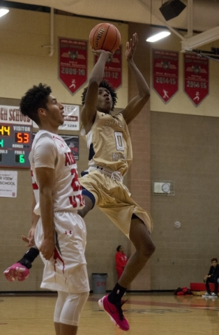 Shadow Ridge‘­s Jerell Springer (0) shoots as Arbor View‘­s Rashaad Thomas (22 ...