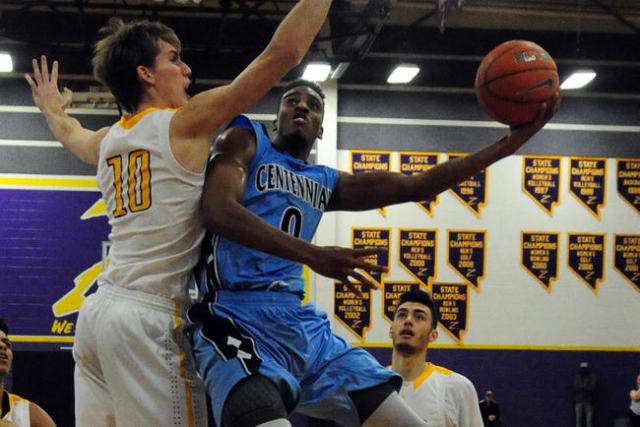 Centennial guard Troy Brown (0) scores a field goal against Durango forward Jason Landman (1 ...