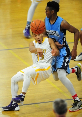 Durango guard Demetrius Valdez (13) passes while falling backwards into Centennial guard Tro ...