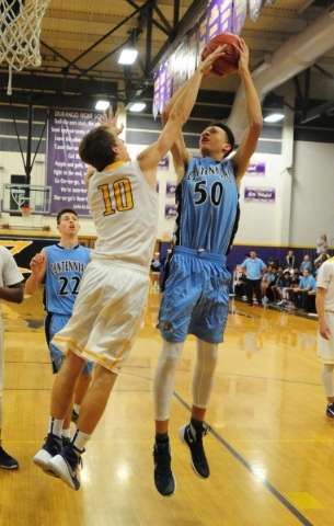 Centennial center Darian Scott (50) goes up for a shot against Durango forward Jason Landman ...