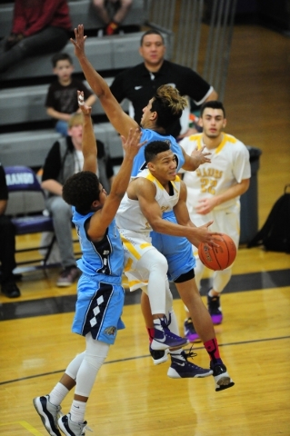 Durango guard Demetrius Valdez (13) goes up for a shot while being double covered by Centenn ...