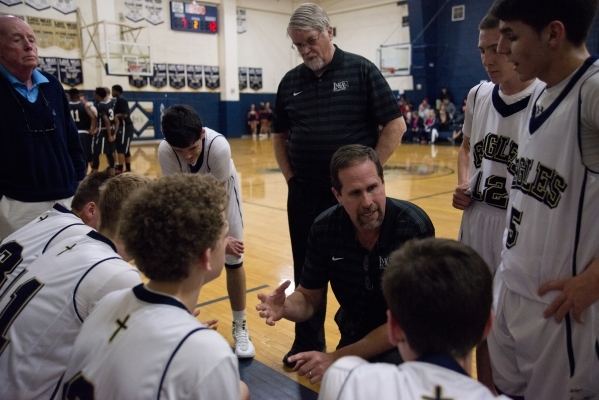 Lake Mead Christian Academy basketball head coach Jeff Newton speaks with his team during th ...