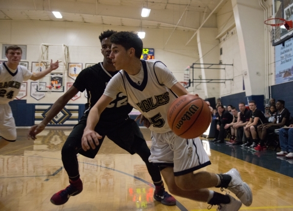 Lake Mead‘s Austin Newby (5) works the ball around Mountain View‘s Tyrell Brooks ...