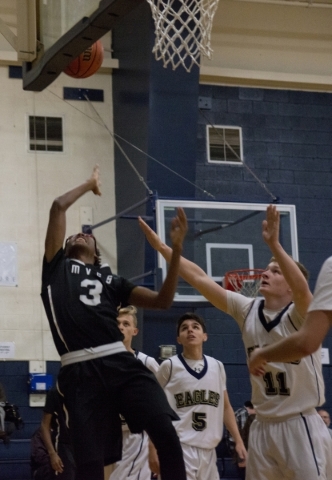 Mountain View‘s Terrence Brooks (3) takes a shot at the basket while falling to the fl ...