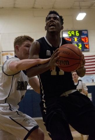 Mountain View‘s Tevin Gray (11) attempts to take the ball to the basket as Lake Mead&l ...