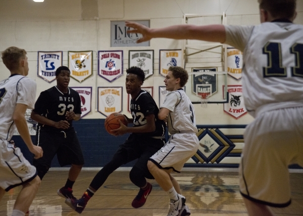 Mountain View‘s Tyrell Brooks (22) works the ball around Lake Mead‘s Brenden Fos ...