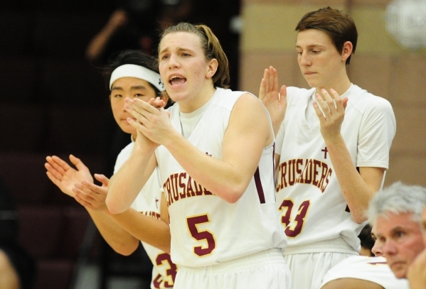 Faith Lutheran guard Gary Tharaldson (5) and teammates celebrate a big scoring run against S ...