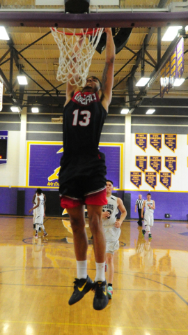 Liberty guard Dyllan Robinson dunks against Coral Academy in the second half of their prep b ...