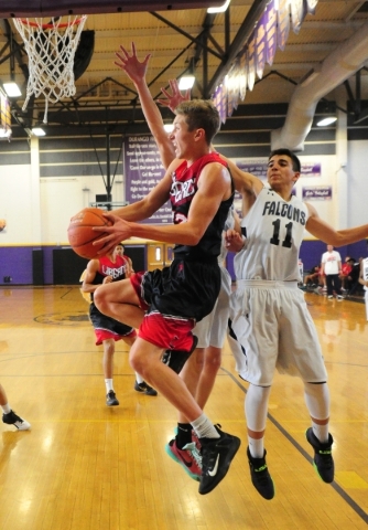 Liberty guard Kyle Thaxton, left, scores against Coral Academy forward Adam Abdalla in the f ...