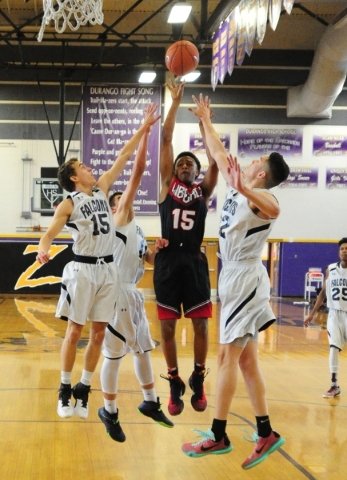 Liberty guard Cameron Burist (15) goes up for a shot while being guarded by Coral Academy fo ...