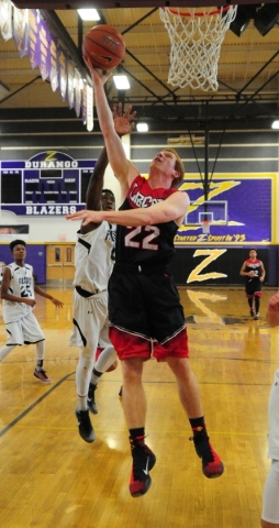 Liberty guard Braden Cain (22) goes up for a shot in front of Coral Academy forward Ryan Dji ...