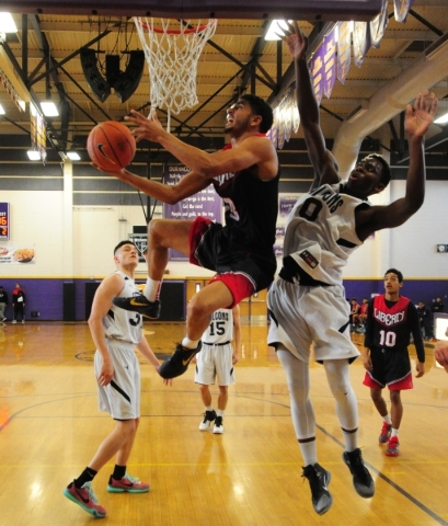 Liberty guard Dyllan Robinson (13) is fouled by Coral Academy forward Ryan Djino (0) in the ...