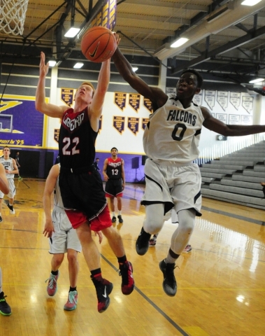 Coral Academy forward Ryan Djino (0) knocks the ball away from Liberty guard Braden Cain (22 ...