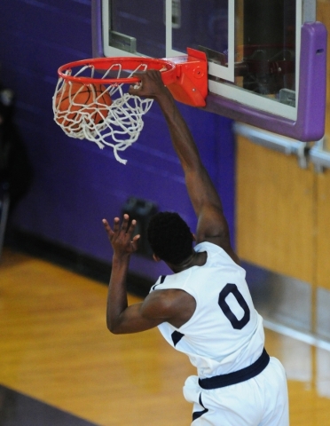 Coral Academy forward Ryan Djino dunks against Liberty in the first half of their prep baske ...