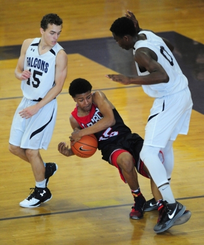 Liberty guard Cameron Burist (15) is fouled by Coral Academy forward Ryan Djino (0) while gu ...