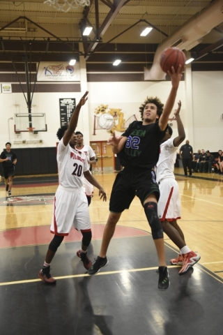 Green Valley‘s Xavier Jarvis (32) goes up for a lay-up against Las Vegas defenders Eri ...