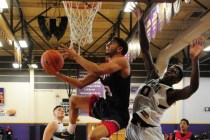 Liberty guard Dyllan Robinson (13) is fouled by Coral Academy forward Ryan Djino (0) in the ...